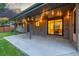 Inviting covered patio area with string lights and a view of the landscaped backyard at 2644 S Krameria St, Denver, CO 80222