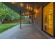 Covered patio with string lights, a brick exterior, and a view of the backyard at 2644 S Krameria St, Denver, CO 80222