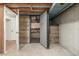 Basement safe room featuring reinforced door and custom wood shelving at 2644 S Krameria St, Denver, CO 80222
