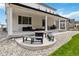 Extended covered patio with ample seating and fire pit, perfect for outdoor gatherings and relaxation at 1369 E Witherspoon Dr, Elizabeth, CO 80107