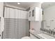 Well-lit bathroom featuring a black and white striped shower curtain and a granite countertop at 1369 E Witherspoon Dr, Elizabeth, CO 80107