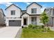 Charming two-story home featuring a well-manicured lawn and a welcoming front porch with inviting seating at 1369 E Witherspoon Dr, Elizabeth, CO 80107