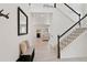 Elegant foyer showcasing a staircase, a modern light fixture, and a chic bench with convenient storage solutions at 1369 E Witherspoon Dr, Elizabeth, CO 80107
