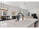 Open kitchen view into dining and living area featuring a black kitchen faucet at 1369 E Witherspoon Dr, Elizabeth, CO 80107