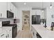 Modern kitchen with white cabinets, black appliances, and large island at 1369 E Witherspoon Dr, Elizabeth, CO 80107