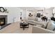 Open-concept living area featuring a fireplace, a comfortable sofa, and seamless flow to the kitchen and dining area at 1369 E Witherspoon Dr, Elizabeth, CO 80107