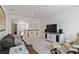 Open-concept living area featuring neutral tones, stylish furniture and a view of the staircase at 1369 E Witherspoon Dr, Elizabeth, CO 80107
