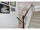 Elegant staircase with white railings, dark wood accents, and contemporary wall art at 1369 E Witherspoon Dr, Elizabeth, CO 80107