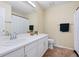 Bright bathroom with a large mirror, extended vanity and combination tub and shower at 9138 Gale Blvd # 2, Thornton, CO 80260