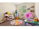 Bright bedroom with colorful decor, play area, and a sunny window at 9138 Gale Blvd # 2, Thornton, CO 80260