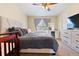 Comfortable bedroom with a soft carpet, bed, dresser, and natural light at 9138 Gale Blvd # 2, Thornton, CO 80260