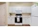 Efficient kitchen with white cabinetry, laminate countertops, and a range of appliances for cooking at 9138 Gale Blvd # 2, Thornton, CO 80260