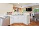 Modern kitchen featuring white cabinets, stainless appliances, and open layout to dining area at 9138 Gale Blvd # 2, Thornton, CO 80260
