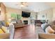 Open-concept living and dining area featuring a fireplace, stylish furniture, and sliding glass doors at 9138 Gale Blvd # 2, Thornton, CO 80260
