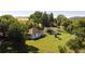 Aerial view of the property showcasing the house, barn, large trees and pasture at 6145 S Perry Park Rd, Sedalia, CO 80135
