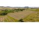 Expansive property featuring a freshly cut hay field, mature trees, and distant mountain views at 6145 S Perry Park Rd, Sedalia, CO 80135