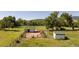Aerial view showcasing the home and outbuildings on a beautiful lot with horse fencing at 6145 S Perry Park Rd, Sedalia, CO 80135