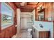 Charming bathroom with white subway tile, wood-paneled walls and patterned tile floor at 6145 S Perry Park Rd, Sedalia, CO 80135