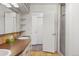 Bright bathroom with double sinks, tile floor, and a glass-enclosed shower at 6145 S Perry Park Rd, Sedalia, CO 80135