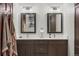 Bathroom features double sinks, modern fixtures, and dark wood cabinets at 6145 S Perry Park Rd, Sedalia, CO 80135