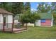 Exterior view of outbuilding, deck and American flag art at 6145 S Perry Park Rd, Sedalia, CO 80135