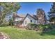 A charming home featuring a stone chimney, complemented by well-maintained landscaping at 6145 S Perry Park Rd, Sedalia, CO 80135