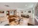 Open-concept living room with hardwood floors and ample natural light at 6145 S Perry Park Rd, Sedalia, CO 80135