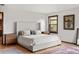 Serene main bedroom with a plush bed, decorative rugs, and natural light from the window at 6145 S Perry Park Rd, Sedalia, CO 80135