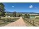 Expansive rural property featuring fenced pastures and several outbuildings against mountain views at 6145 S Perry Park Rd, Sedalia, CO 80135