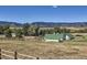 Rural land with multiple outbuildings and stables showcasing a spacious landscape and mountain views at 6145 S Perry Park Rd, Sedalia, CO 80135