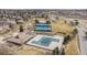 Overhead view of community amenities including tennis courts, a pool, and clubhouse, surrounded by green spaces at 5797 S Laredo Ct, Centennial, CO 80015