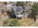 Aerial perspective displays a home featuring a rear deck and solar panels, nestled among mature trees and landscaping at 5797 S Laredo Ct, Centennial, CO 80015