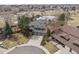 Overhead view of the property showcasing a home near a tranquil pond and lush greenery, providing a serene setting at 5797 S Laredo Ct, Centennial, CO 80015