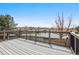 Beautiful back deck overlooking a serene pond with lush trees and scenic views at 5797 S Laredo Ct, Centennial, CO 80015