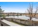 Scenic back deck offers picturesque views of a pond and landscaping at 5797 S Laredo Ct, Centennial, CO 80015