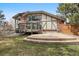 Backyard featuring a deck, patio, and well-maintained lawn at 5797 S Laredo Ct, Centennial, CO 80015
