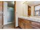 Bathroom featuring a vanity with tile countertop and a glass door shower at 5797 S Laredo Ct, Centennial, CO 80015