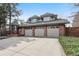 View of the exterior featuring a three car garage and mature trees at 5797 S Laredo Ct, Centennial, CO 80015