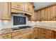 Kitchen with tile backsplash, range hood and wooden cabinetry at 5797 S Laredo Ct, Centennial, CO 80015