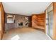 Spacious living room with brick fireplace, wet bar, wood walls, and tile flooring at 5797 S Laredo Ct, Centennial, CO 80015