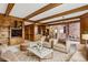 Cozy living room with beamed ceilings, built-in shelving, and comfortable seating at 5797 S Laredo Ct, Centennial, CO 80015