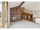Open concept living room with brick fireplace and stairs at 5797 S Laredo Ct, Centennial, CO 80015