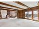 Spacious living room with wood ceilings, fireplace, and deck access at 5797 S Laredo Ct, Centennial, CO 80015