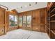 Bright room featuring wood paneling, large windows, and ample natural light at 5797 S Laredo Ct, Centennial, CO 80015
