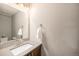 Neutral half-bathroom featuring a sleek countertop, modern sink, and updated fixtures at 10145 Deerfield St, Firestone, CO 80504