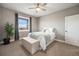 Cozy bedroom features a neutral color palette, a large window, and a comfortable bed at 10145 Deerfield St, Firestone, CO 80504