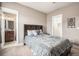 Inviting bedroom with bed with built in headboard, and ensuite bathroom at 10145 Deerfield St, Firestone, CO 80504