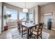 Cozy dining room with large windows, hardwood flooring, and backyard views at 10145 Deerfield St, Firestone, CO 80504