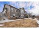 Two-story home with a stone and siding exterior and well-maintained landscaping at 10145 Deerfield St, Firestone, CO 80504