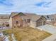 Beautiful home featuring stone and siding, well maintained yard and three car garage on a sunny day at 10145 Deerfield St, Firestone, CO 80504